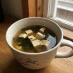 Quick and Cozy Mug Miso Soup 6 Warm mug of miso soup with tofu cubes, seaweed, and green onions