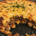 Baked cheesy hamburger rice casserole topped with melted golden cheese