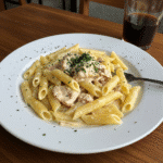 Creamy garlic parmesan chicken pasta topped with parsley in a bowl