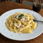 Garlic Parmesan Chicken Pasta 5 Creamy garlic parmesan chicken pasta topped with parsley in a bowl