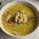 Chicken and Rice Soup 5 Bowl of chicken and rice soup with carrots, celery, and herbs